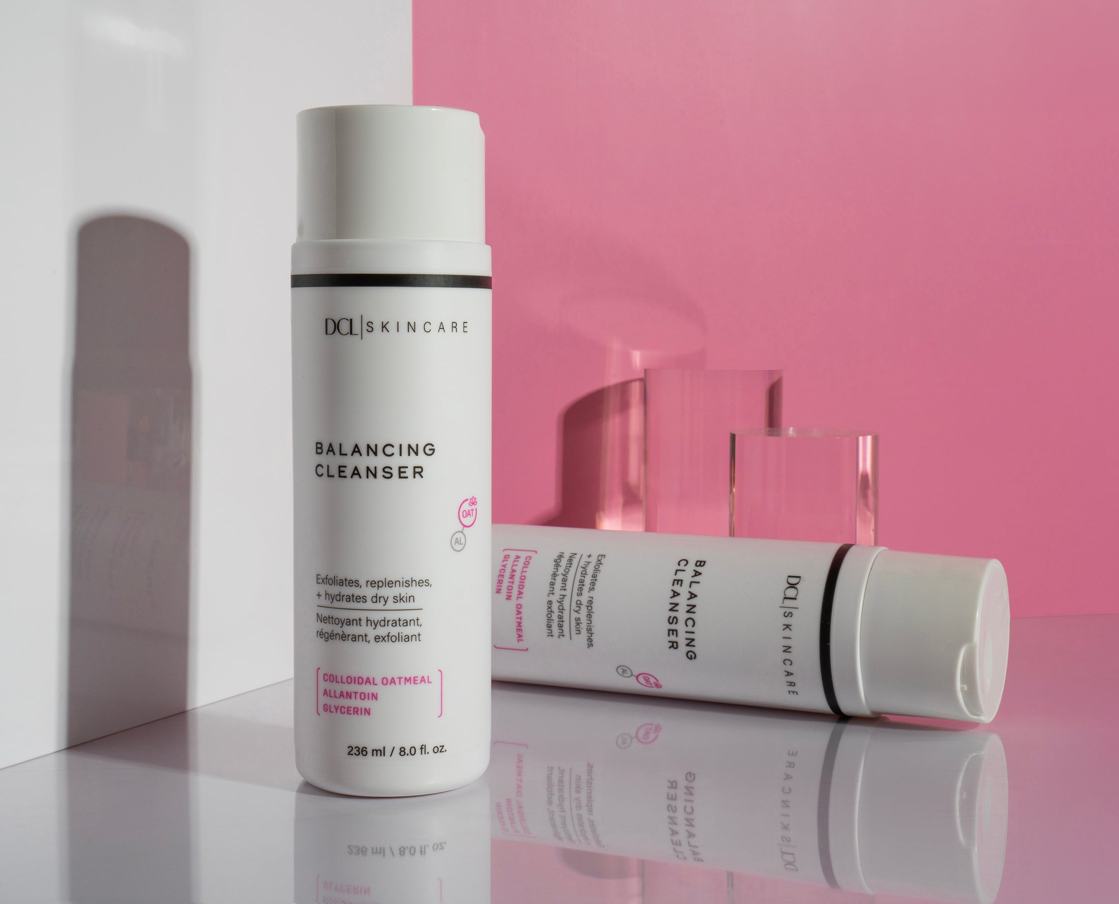 balancing cleanser duo tall and lay on pink and white split backgound